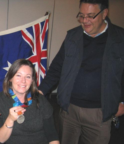 The Rotary Club of Strathfield's Sargent-at-Arms Past President Doug Potter admires Tina Mckenzie's silver medal from the Athens Paralympic Games